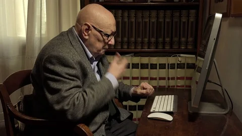 Elder can not use the computer: old worried and angry man using the computer Stock Footage 74437377