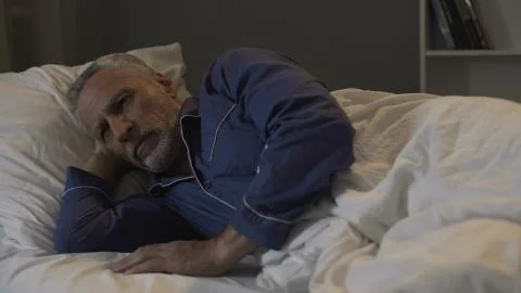 Elder cannot fall asleep, exhausted by bad thoughts and sad memories, insomnia 스톡 사진
