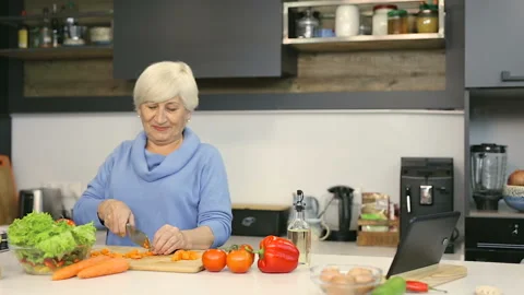 Elder couple cooking at the kitchen. Stock Footage 102449626