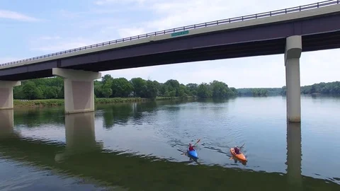 Elder couple kayaking down calm river Stock Footage 76944900