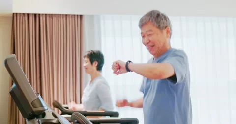 Elder couple run on treadmill Stock Footage 163715926