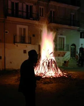 Elder Devotee Silhouetted by San Giuseppe's Bonfire Stock Photos