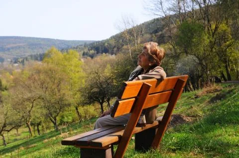 Elder lady on bench Stock Photos