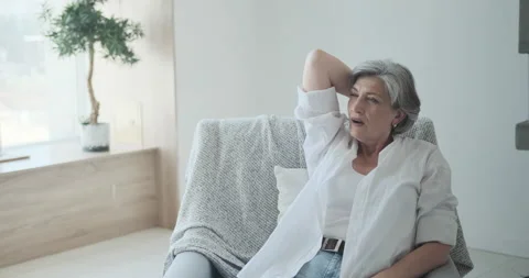 Elder lady reclining back on comfy chair, joyful mature senior female in living Stock Footage 159165004