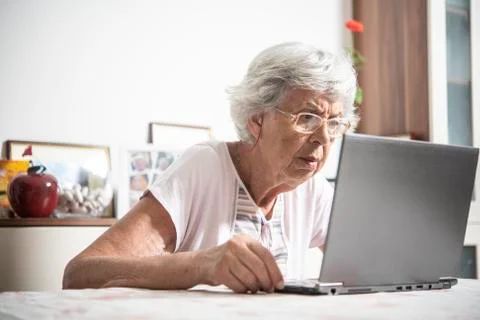 An elder lady using a laptop Stock Photos