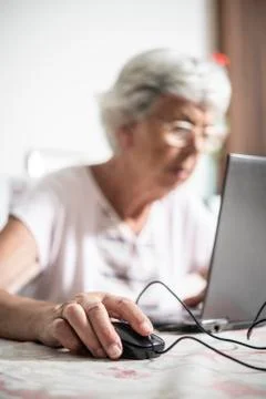 An elder lady using a laptop Stock Photos