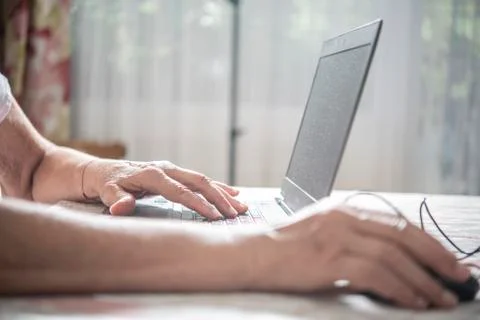 An elder lady using a laptop Stock Photos