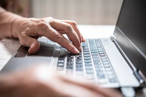 An elder lady using a laptop Stock Photos