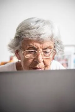 An elder lady using a laptop Stock Photos