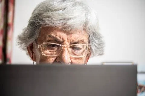 An elder lady using a laptop Stock Photos
