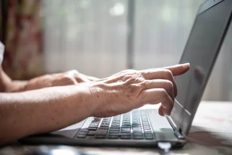 An elder lady using a laptop Stock Photos