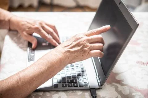 An elder lady using a laptop Stock Photos