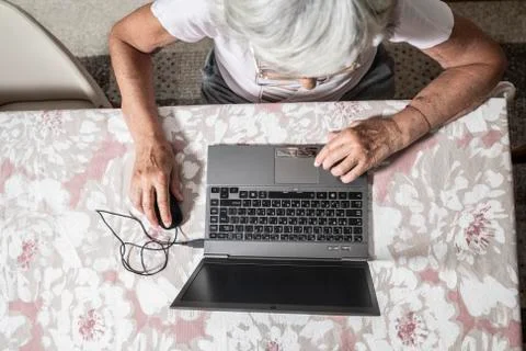 An elder lady using a laptop Stock Photos