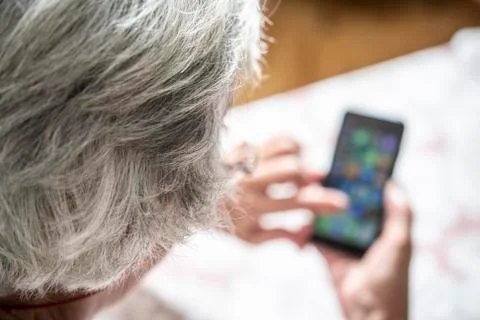 An elder lady using a smartphone Stock Photos