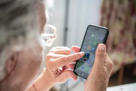 An elder lady using a smartphone Stock Photos