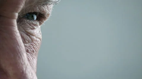 Elder man eye; old man's eye; pensive old man closeup portrait Stock Footage