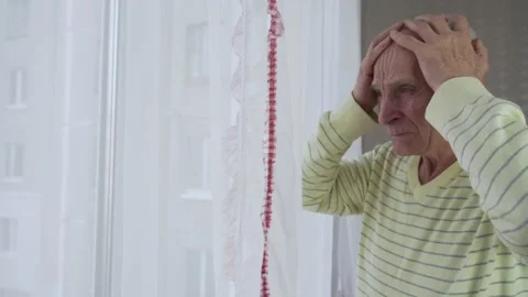 Elder man holds head with hands and suffer from headache Stock Footage 169749436
