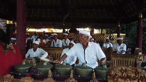 Elder Man Plays Ancient Musical Gamelan Music in Spiritual Ceremony at Video stock 240921453