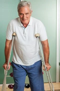 Elder man using a crutches Stock Photos