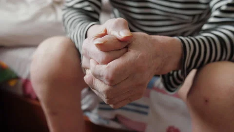 Elder senior man sit alone wrinkled skin hands folded Stock Footage 149579723