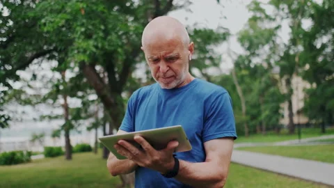 Elder Senior Using Wireless Tablet PC. Retiree Learning New Internet Stock Footage 148467989