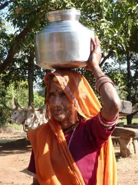Elder woman with container on head Stock Photos