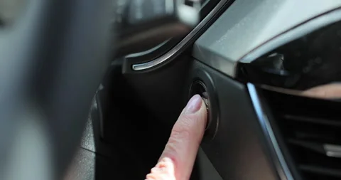 Elder woman presses engine start button in car. Stock Footage 334099868