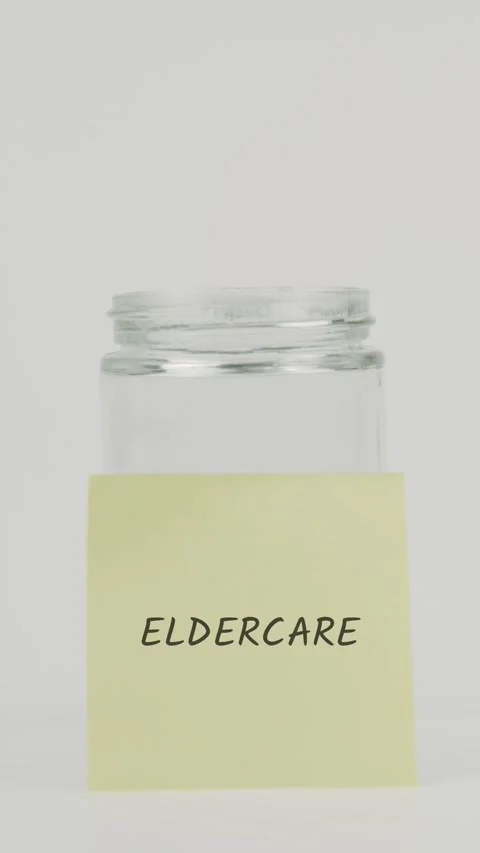 Eldercare text or word on yellow sticky note attached to glass jar with hand Stock Footage 311724589