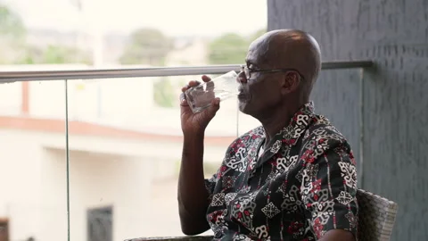 Elderly African Man Drinking Glass of Water for Healthy Hydration Video stock 346007773