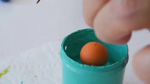 Elderly artiest making arts and crafts necklace, painting polymer clay bead with Stock Footage 77100341