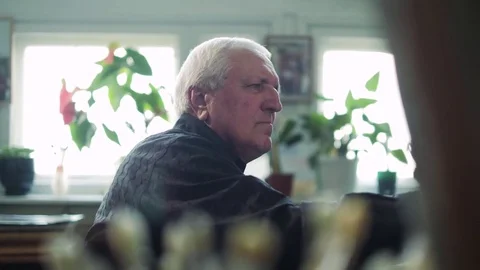 An elderly artist writes a picture in his studio 4k Stock Footage