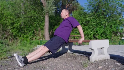 Elderly athletic man 62 years old training on the sports ground. Push-ups. Stock Footage 310439201