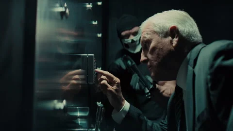 Elderly banker entering the code to the bank vault Stock Footage 262328705