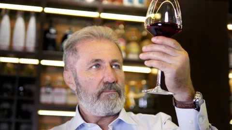 An elderly, bearded, gray-haired, well-dressed sommelier, a male winemaker Stock Footage 159544865