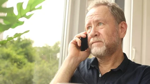 Elderly bearded man talking on smartphone calm serious face expression business 스톡 동영상 110840290