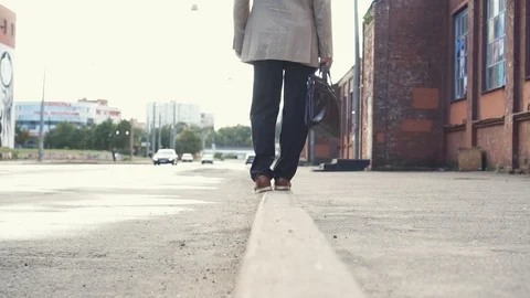 Elderly businessman in a jacket with briefcase have fun, walking on the border Stock Footage 101505283