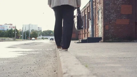 Elderly businessman in a jacket with briefcase have fun, walking on the border Stock Footage 101505454