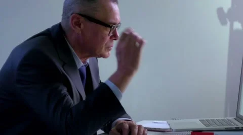 Elderly businessman working with computer in office. he takes off his glasses Stock Footage 60405044