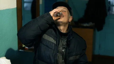Elderly Caucasian man skillfully drinks vodka from a glass. Russian traditional Stock Footage