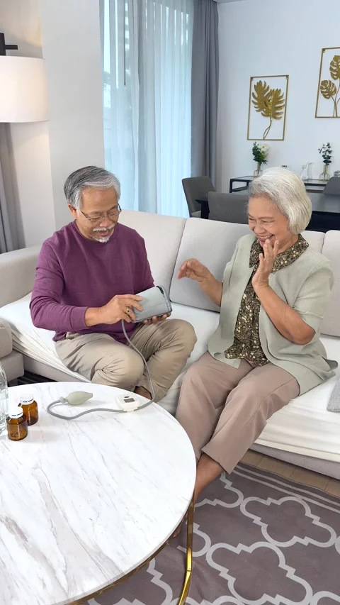 Elderly Couple Checking Blood Pressure Together at Home Stock Footage 329087100