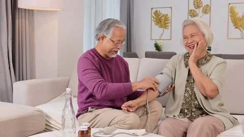Elderly Couple Checking Blood Pressure at Home Stock Footage 329087140