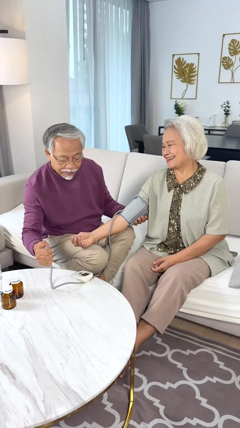 Elderly Couple Checking Blood Pressure Together at Home Stock Footage 332038361