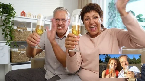 Elderly Couple Connected with their Adult Children using Laptop Video Call Stock Footage