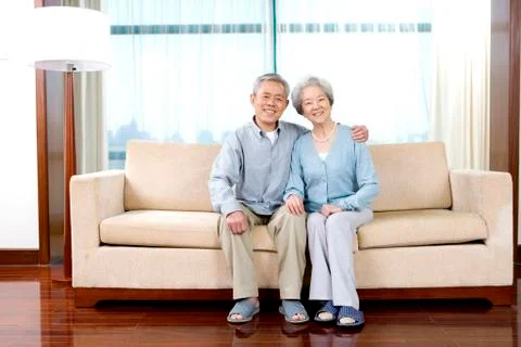 Elderly couple on couch Stock Photos