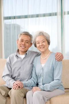 Elderly couple on couch Stock Photos