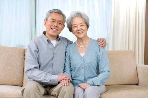 Elderly couple on couch Stock Photos