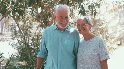 Elderly couple embracing in spring park outdoors having fun and enjoying togethe Stock Footage 196463904