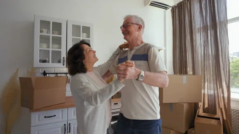 Elderly couple enjoys dancing in kitchen after relocation Stock Footage 201168666