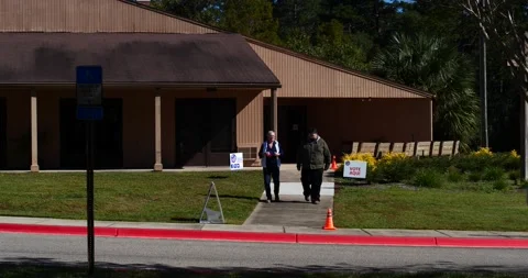 Elderly couple exiting precinct after voting, November 3rd, 2020 in Florida Stock Footage 152522165