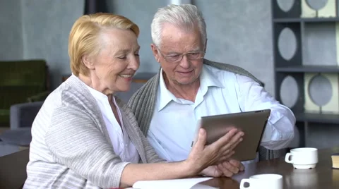 Elderly couple having fun in communicating with family on the internet in 動画素材 63432617